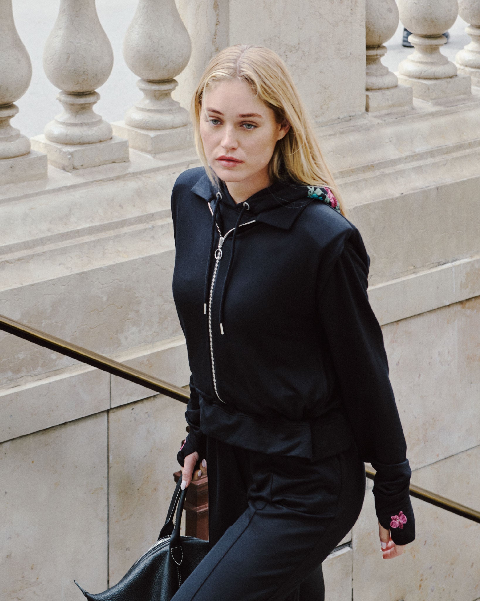 Deméa Paris Alice Hoodie and Alice Pants, Départ imminent capsule, on Paris stone steps.