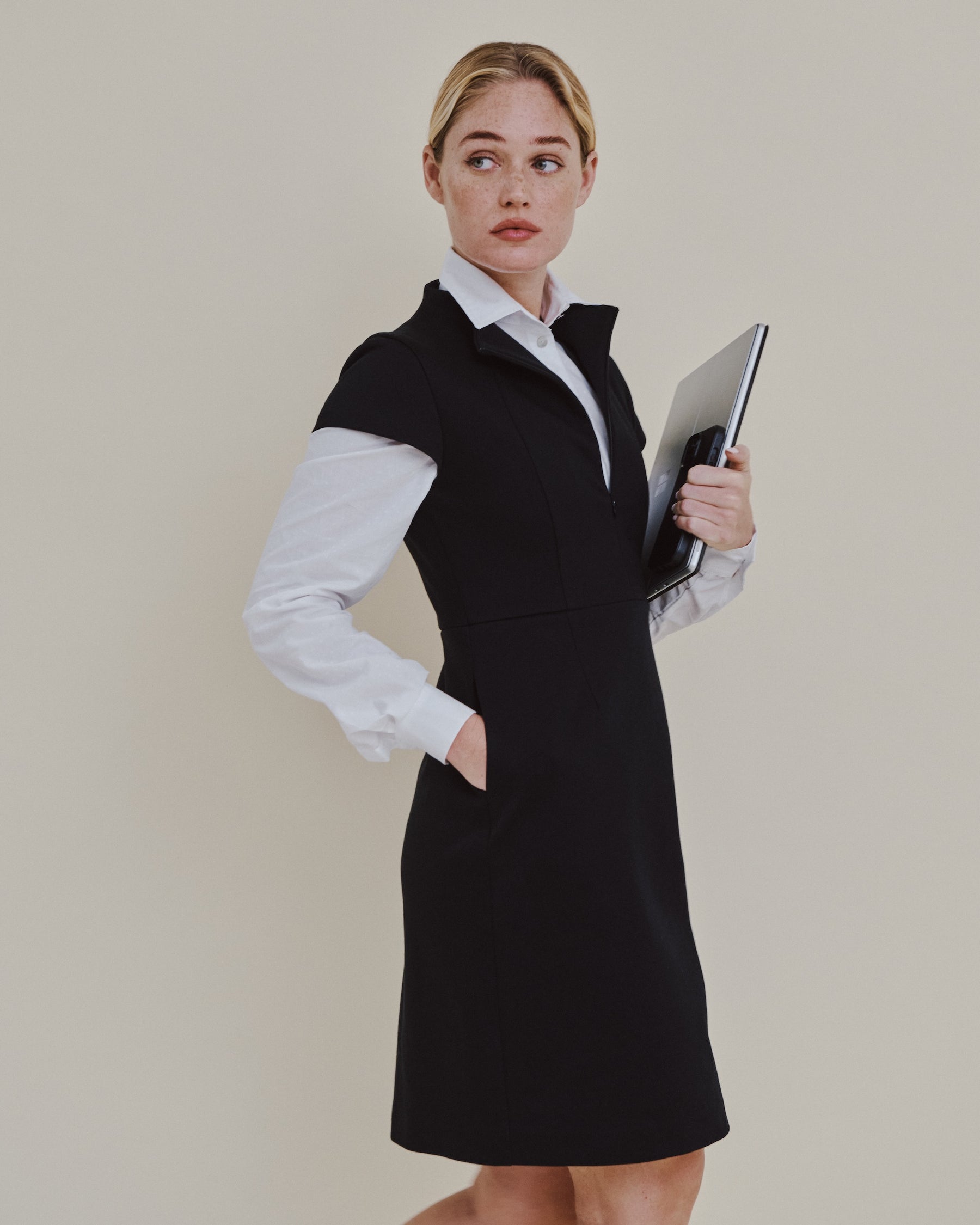 Deméa Paris Aurore Dress layered over the Alia Fitted Shirt, holding a laptop, Work collection.