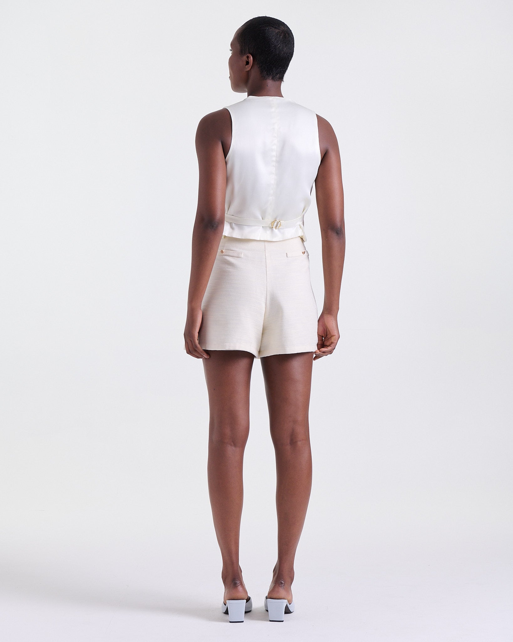 Deméa Paris Ariel Waistcoat and Ariel Shorts in off-white satin, studio shot, back view.